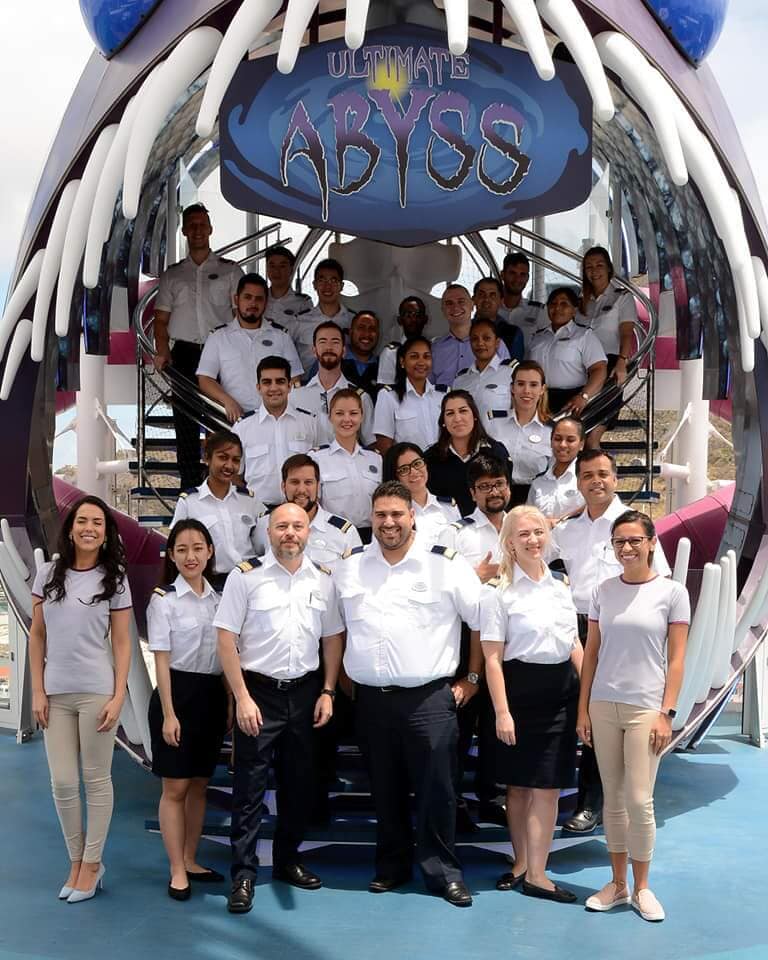 Group posing below a large decorative installation