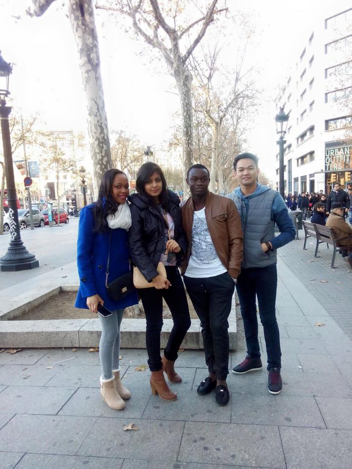 Three people walking along a city street